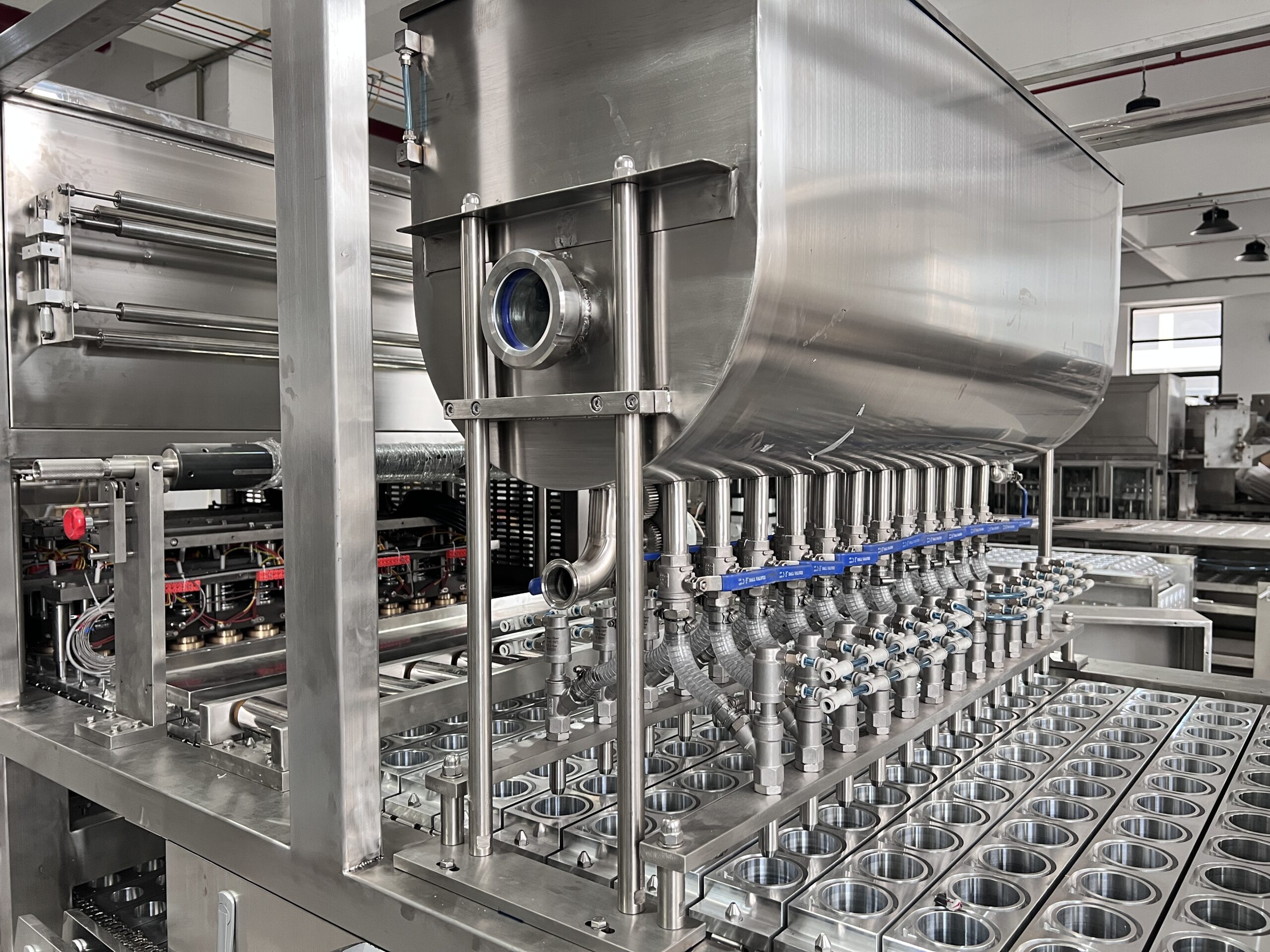 Industrial machinery with metal components and tubes.