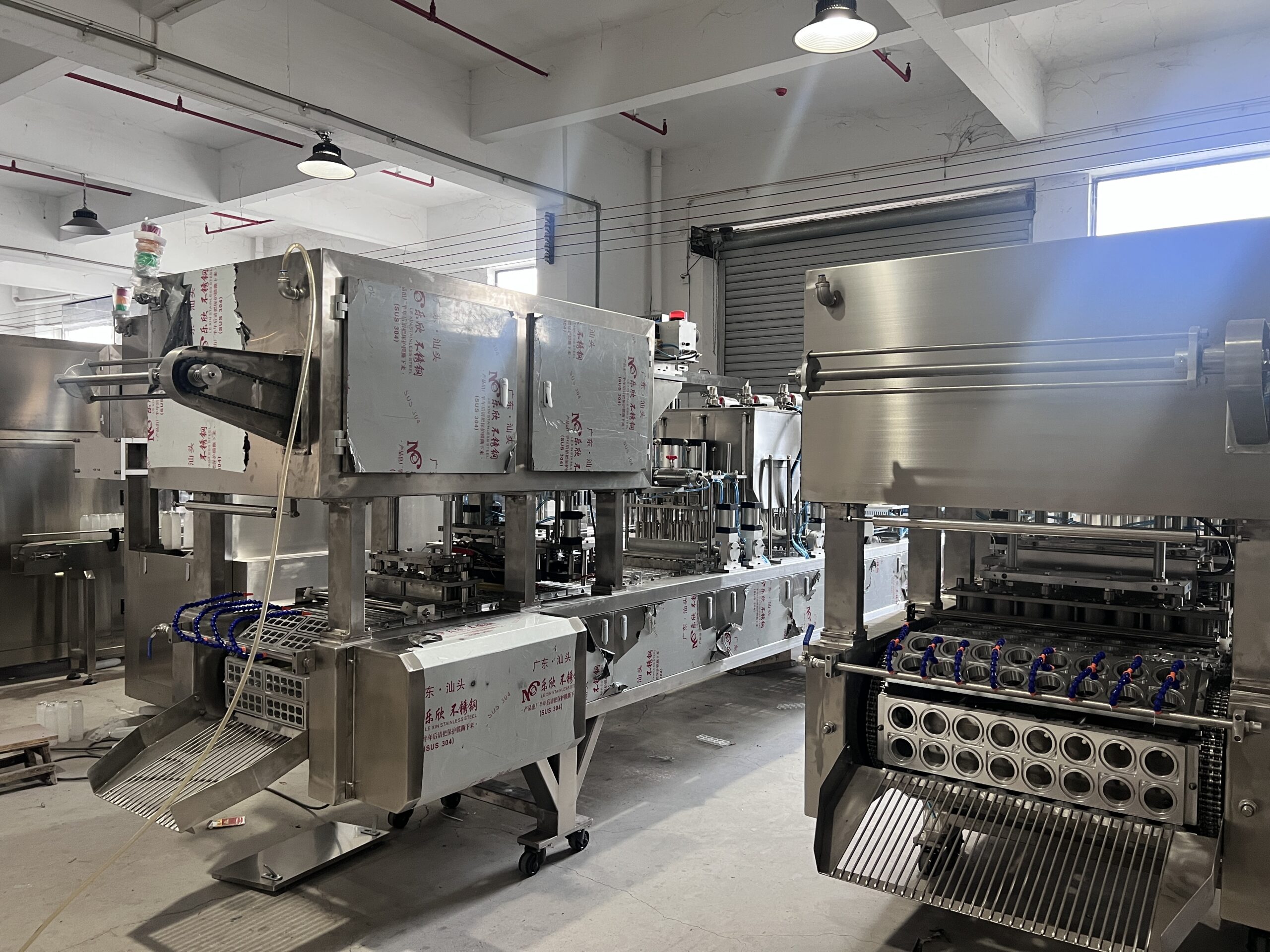 Industrial packaging machines in a factory setting.