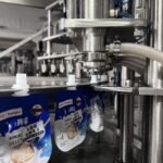 Konjac jelly packaging process in a factory setting.