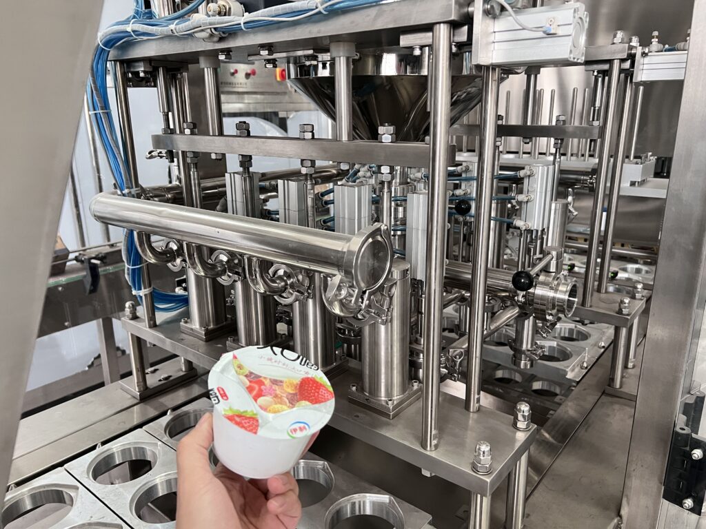 Stainless steel parts of a filling machine being cleaned automatically