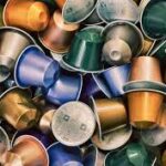Variety of colorful coffee capsules piled together.