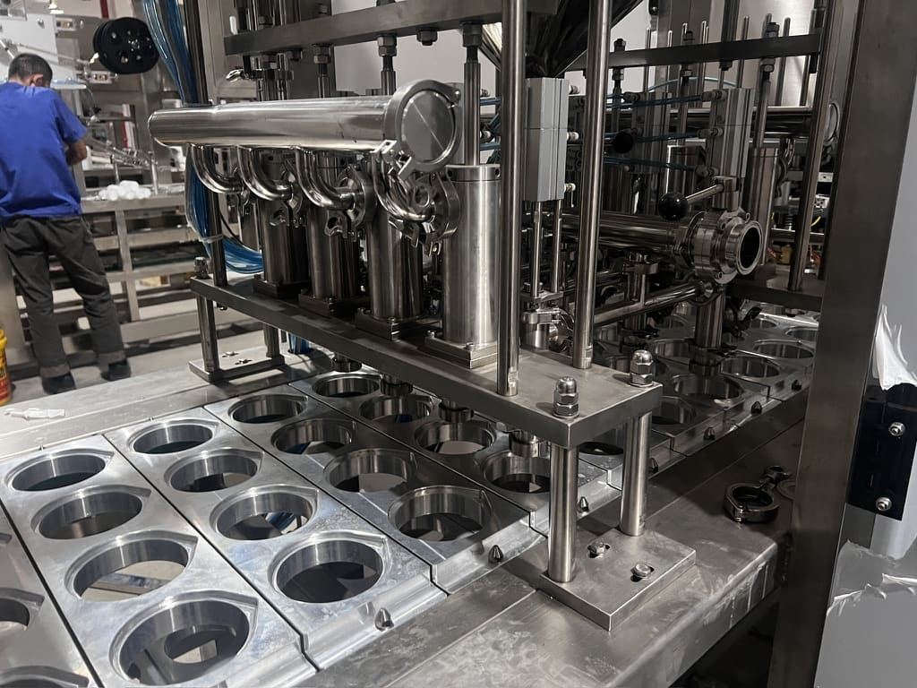 A cup filling and sealing machine in operation