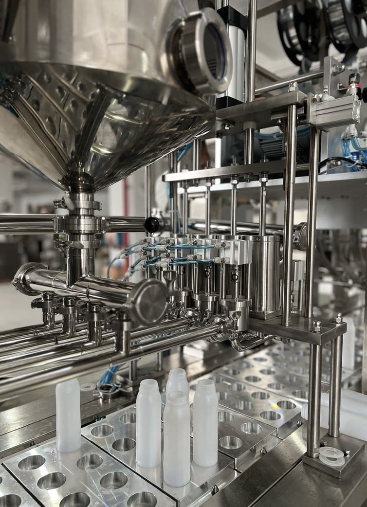 Industrial machinery for bottle filling process.