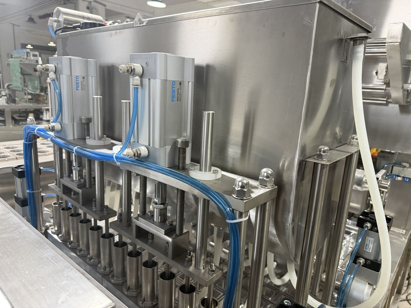 Multi-nozzle cup filling station for product sample and filling volume checks