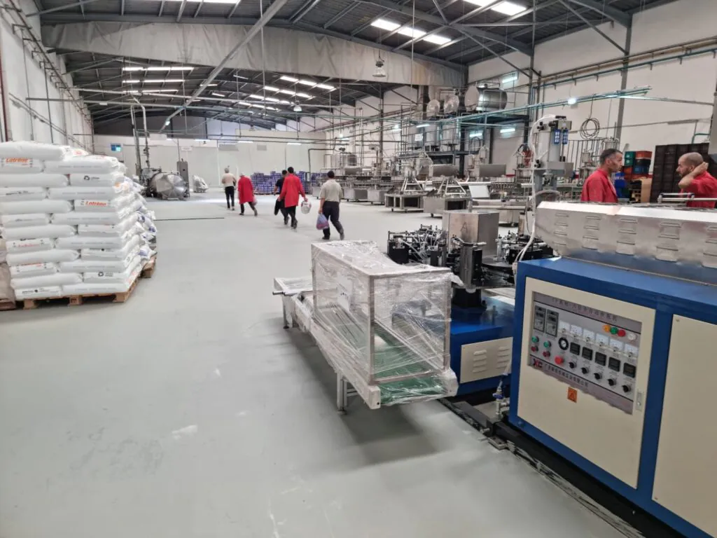 Factory interior with machinery and workers.