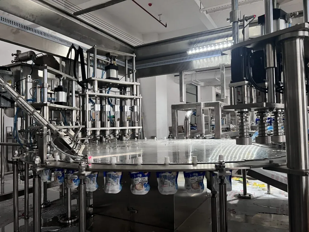 Automated beverage bottling machine in factory.