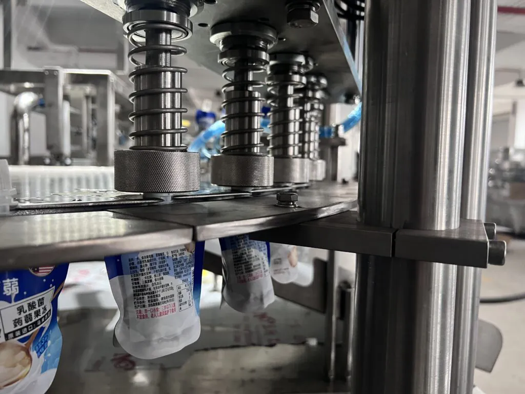 Industrial machine packaging liquid food products.