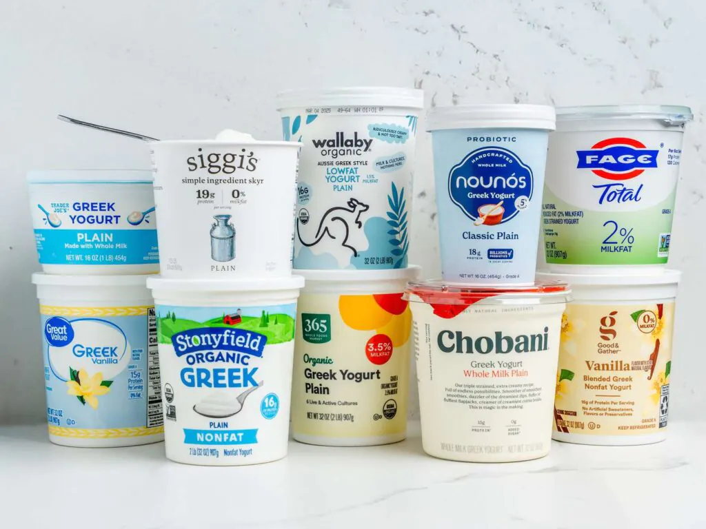 Assorted Greek yogurt containers on white background.